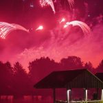 Red Waterfalls over the water at IPC pyromusical